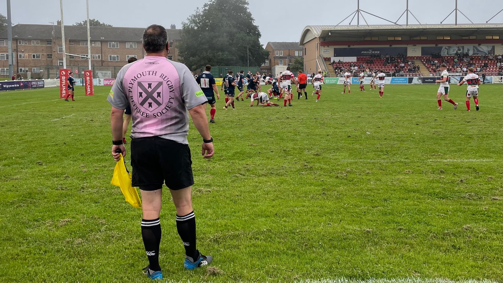 The back of a Rugby referee assistant running the line. Photo by Simon Davies